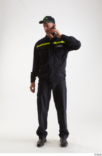 Sam Atkins Fireman with Mobilphone standing talking whole body 0001.jpg